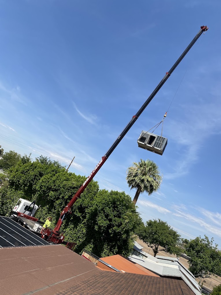 Package HVAC unit being lifted by crane